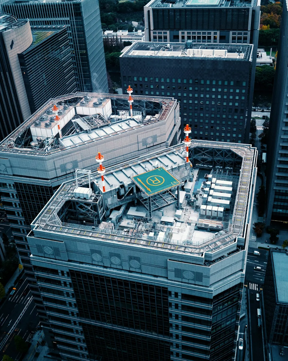 A rooftop helipad between Manhattan towers seen from above